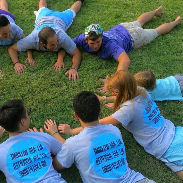 Students in a circle activity with a child